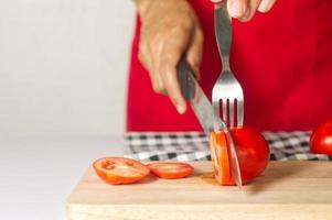 using fork help cutting tomato , kitchen tips for quick way cooking