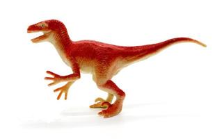 Raptor dinosaurios juguete sobre fondo blanco. foto