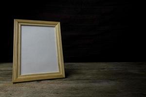Picture frame on wood background photo