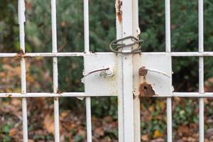 Closeup of a rusty white fence photo