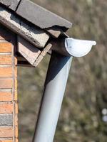 Rain pipe on the roof and wall photo