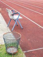 Vertical shot of a chair and basket in a running field photo