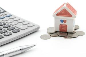 House and calculator on white background photo