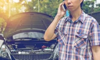 Man Phoning For Help with a broken down car photo