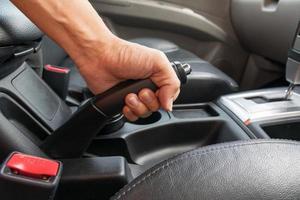 Driver pulling the hand brake in car photo