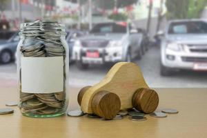 money in the glass bottle with Car showroom background blur photo