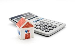 House and calculator on white background photo