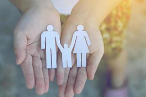 Children hands holding small model of heart and family , concept family photo