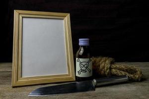 Picture frame and poison and knife. Concept Romance Suspense photo