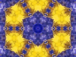 Reflection of colorful flowers in kaleidoscope pattern. Yellow and blue abstract background. Free photo. photo