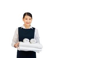 Room service holding fresh white bath towels on white background. Female housekeeper with towels. photo