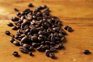 Coffee beans over wooden surface photo