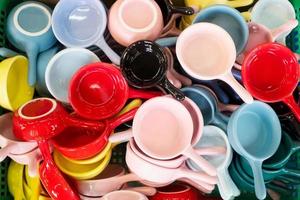 Colorful ceramic coffee mugs in basket , in front of gift shop at Chatuchak Market  ,Bangkok photo