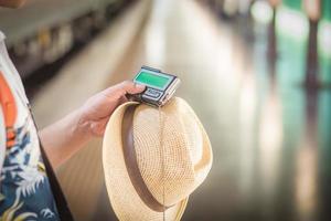 Tourists holding a pager or beeper to send messages photo