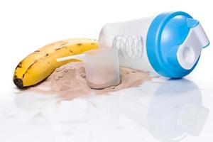 Shaker, protein powder and banana photo