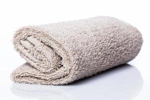 Rolled towel on white background photo