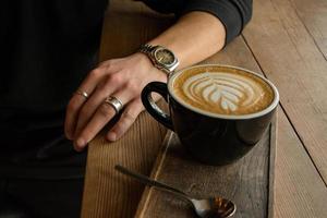 Cup of coffee with latte art in the cafe photo