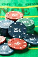 Poker chips on a poker table close-up. Vertical image. photo