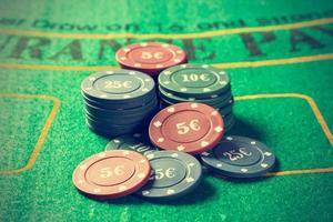 Poker chips on a poker table. Vintage style. Horizontal image. photo