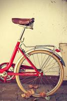 Retro bicycle with autumn leaves on the rear wheel. Vintage style. Vertical image photo