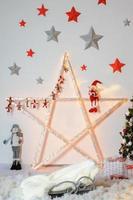 A large Christmas star decorated with festoons and various figures. photo