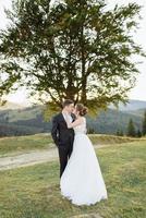 Beautiful bride and groom at the mountains photo