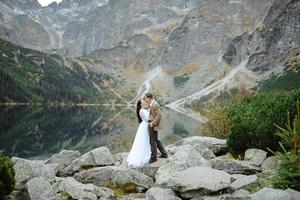 Loving couple on the background of the Sea-eye lake in Poland photo