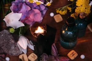 witchcraft concept with potions, herbs and occult equipment photo