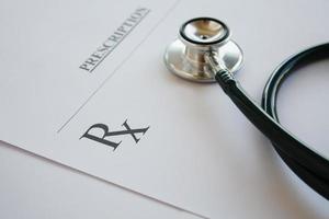 Prescription form lying on table with stethoscope photo