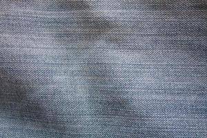 Texture of blue jeans textile close up photo