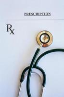 Prescription form lying on table with stethoscope photo