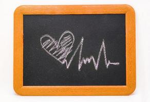 Heartbeat sign, love heart on a chalkboard photo