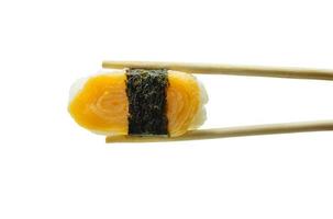 Sushi in chopsticks isolated on white background photo