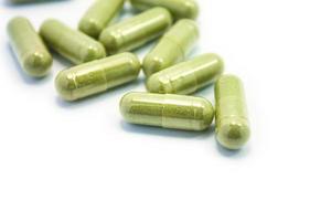 Herbal Drug, an alternative medicine in capsule on white background photo