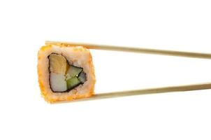 Sushi maki in chopsticks isolated on white background photo