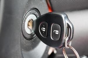 car key inserted into the lock of ignition of the car photo