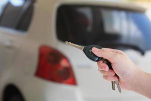 women's hand presses on the remote control car alarm systems photo