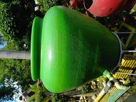 old green jar that has been converted into a hand washing place during the pandemic. natural. green photo