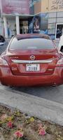 Dubai, UAE April 13,2022, Nissan Altima S in Scarlet Ember Red. Altima is the rebadged export version of the Japanese Nissan Sylphy. Captured during the day in bokeh. Back side view photo