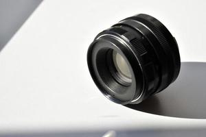 Old camera lens on a white background photo