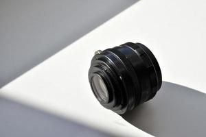 Old camera lens on a white background photo