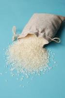 Rice in a bag on table cloth, Top view. photo