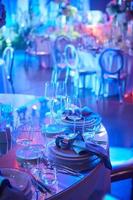 Table setup in purple light. Ready to event. Shallow dof photo