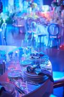 Table setup in purple light. Ready to event. Shallow dof photo