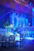 Table setup in blue light. Ready to event. Shallow dof. photo