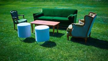 Empty furniture in the park on green grass photo