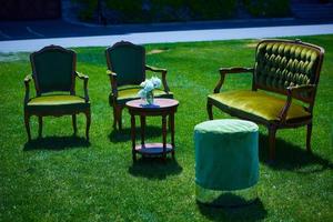 Empty furniture in the park on green grass photo