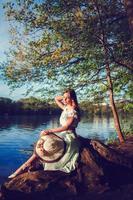 woman with hat at river photo