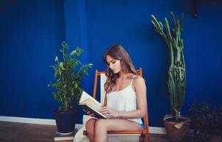 girl with long hair reads a book photo