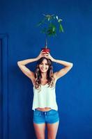 woman holding plants on her head. photo